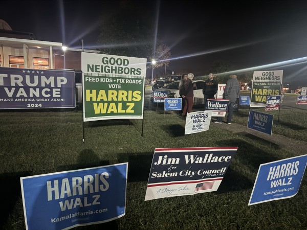 people standing around democratic signs at the Salem Civic Center